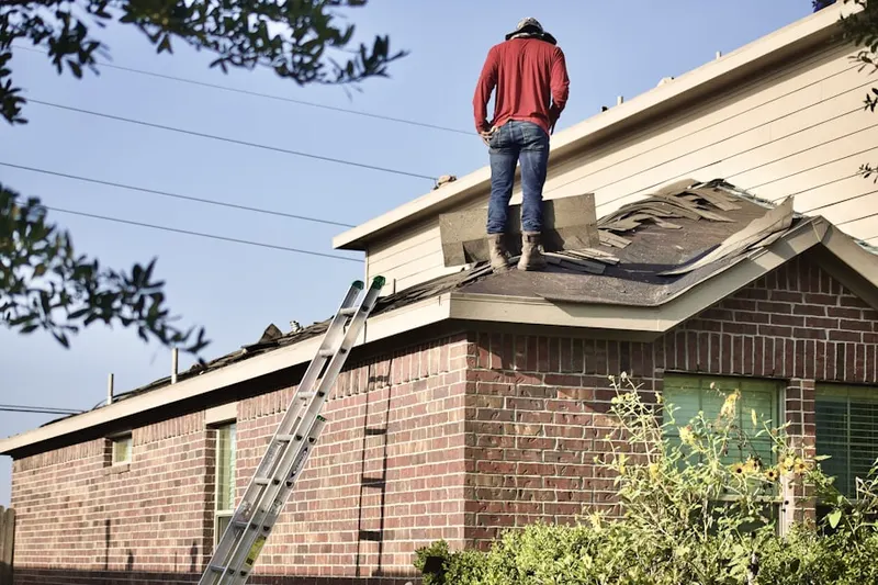 Professional roofer working on a residential roof in Goodes